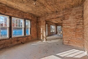 A homeowner meeting with a trusted general contractor to discuss a summer construction project.