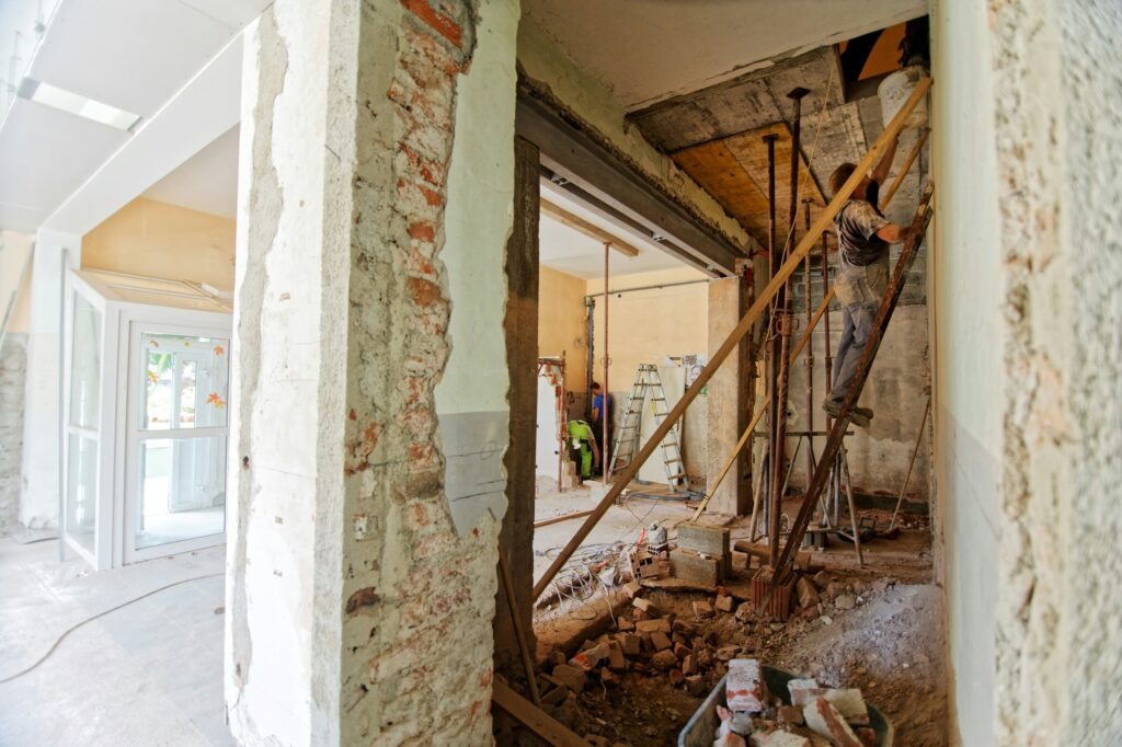 A general contractor reviewing home remodeling plans with a homeowner, ensuring best practices are followed.