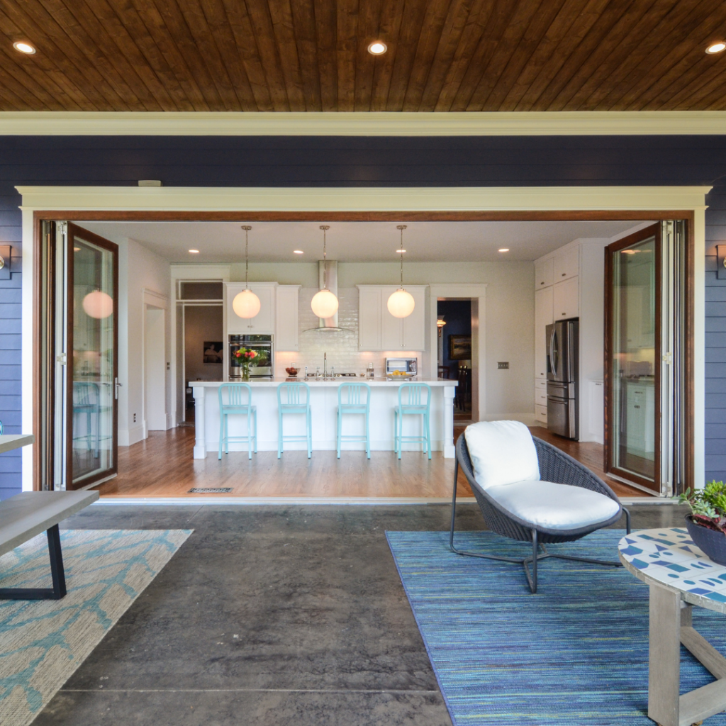 Open-concept kitchen with bi-fold doors connecting indoor and outdoor spaces.