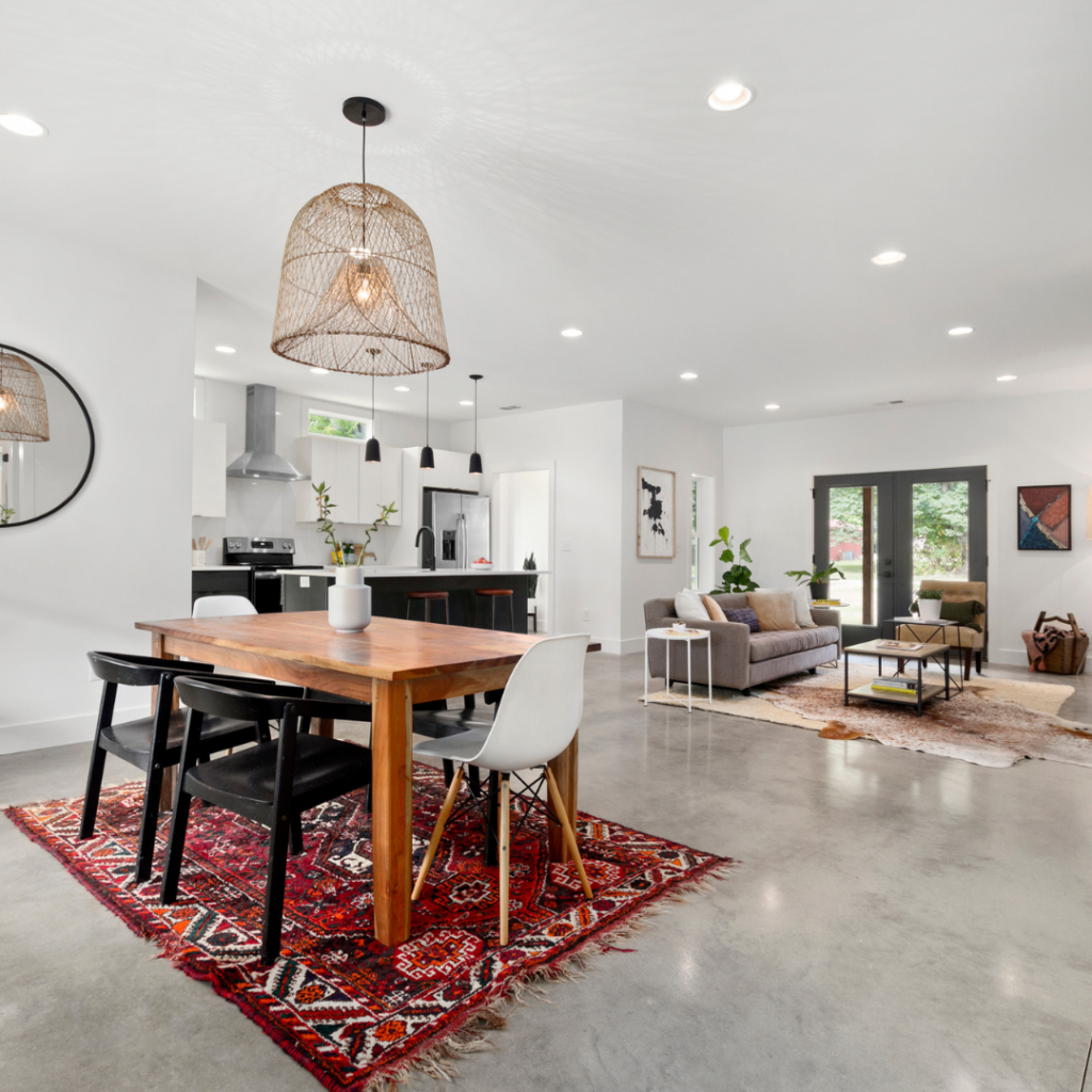 Open-concept home with modern kitchen, dining area, and stylish lighting.