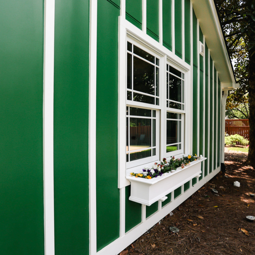Charming green DADU exterior with white trim and a decorative window box.