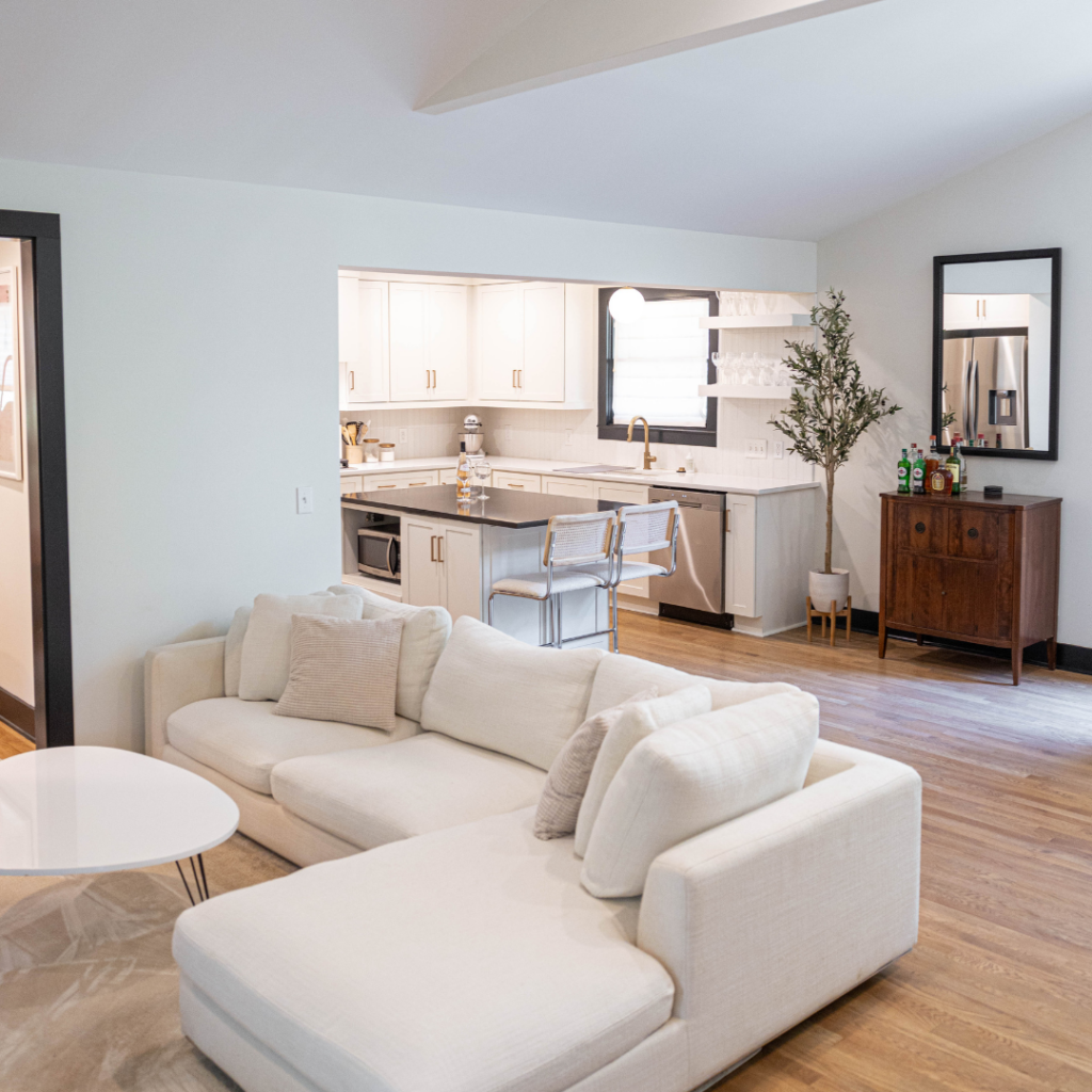Open-concept living room and kitchen with neutral tones and modern finishes.