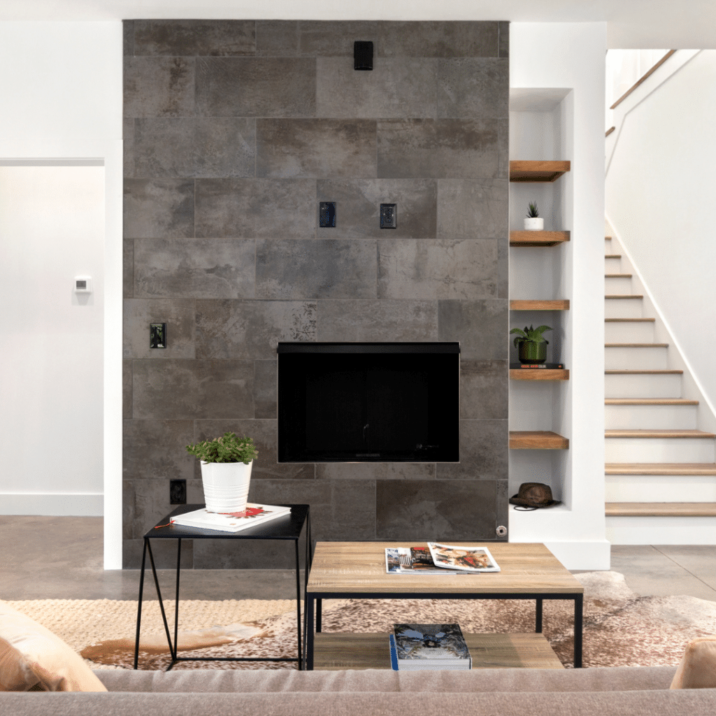 Modern living room with a sleek fireplace and built-in shelving in a custom-built home in Nashville, TN.