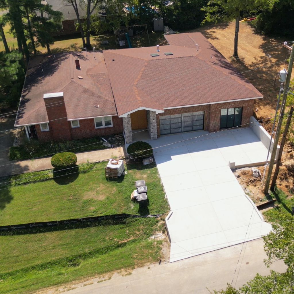 Modern home addition with a newly paved driveway and expanded entrance.