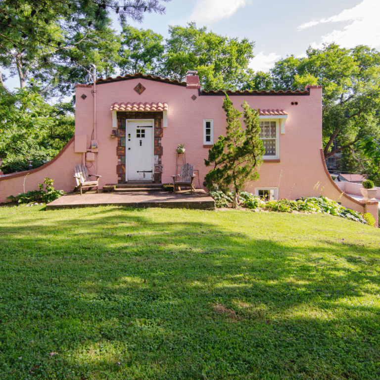 Restored historic Spanish-style home with stucco exterior and terracotta roof.