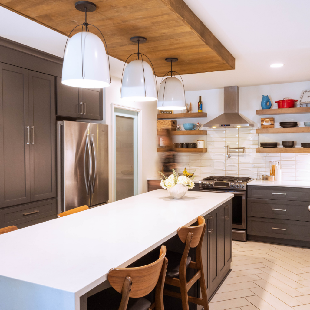 Modern kitchen with dark cabinetry, open shelving, and large pendant lighting.