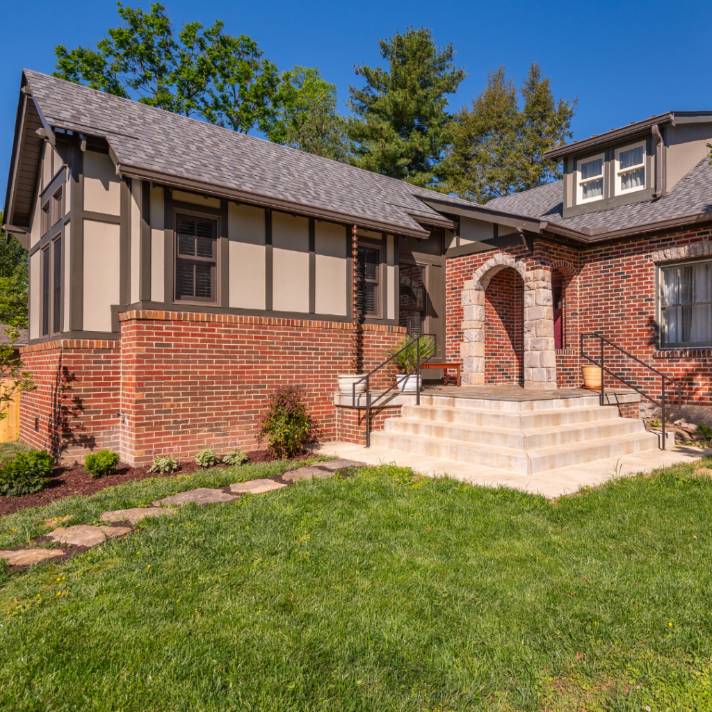 Custom home addition with brick and timber frame details in Nashville, TN, seamlessly blending with the original structure.