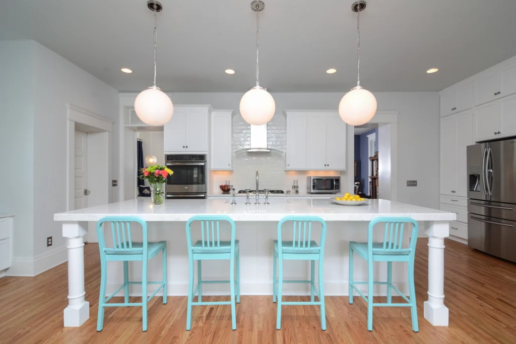 Nashville kitchen remodel with oversized island with seating for 4 and a range hood and full-height backsplash tile